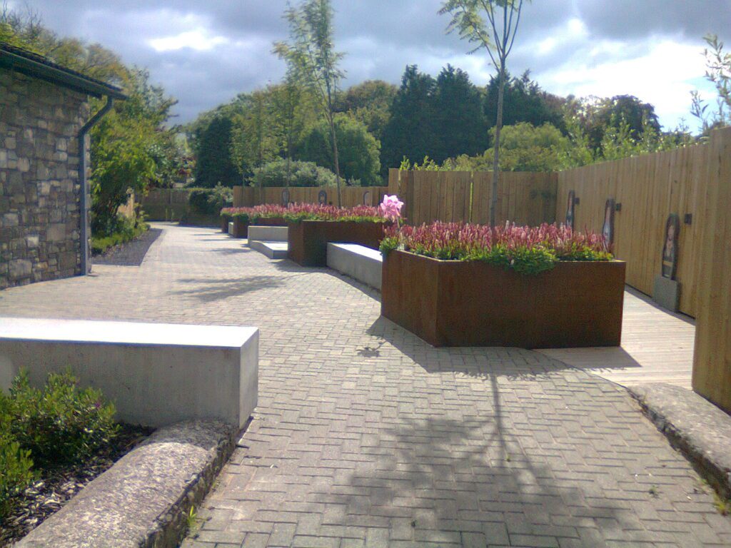 large custom CorTen planters with flowers and seating