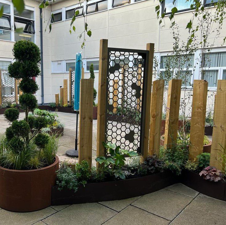 EverEdge planters full of plants with trellis mounted on timber battens creating privacy screens