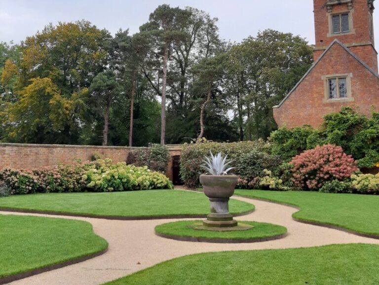 Titan edging curved to create pathways and shaped lawns at this English stately home near a large forest.