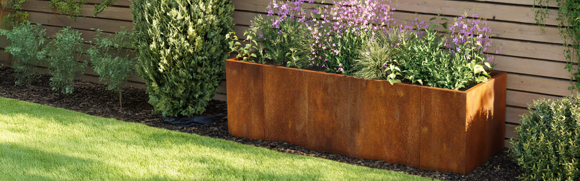http://A%20large%20rectangular%20rust-colored%20metal%20planter%20with%20purple%20and%20green%20plants%20sits%20on%20mulch,%20bordered%20by%20lawn%20edging%20in%20a%20landscaped%20yard,%20backed%20by%20a%20wooden%20fence%20and%20surrounded%20by%20grass%20and%20other%20shrubs.